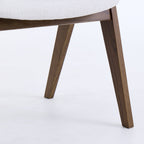 Close-up of a chair with wooden legs on a white background