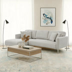 Modern living room with a gray sofa, wooden coffee table, and abstract art on the wall.