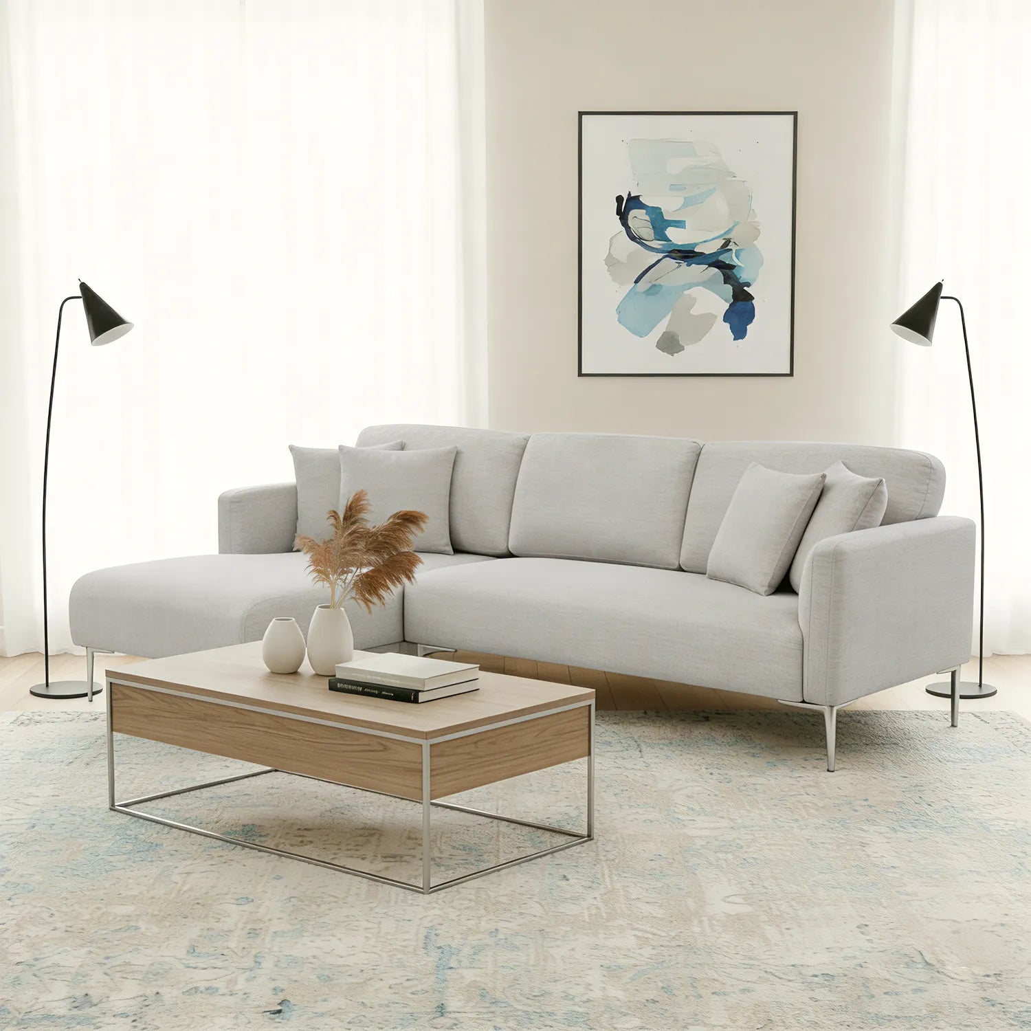 Modern living room with a gray sofa, wooden coffee table, and abstract art on the wall.