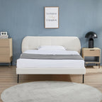 Modern bedroom with a bed, nightstands, and wall art.
