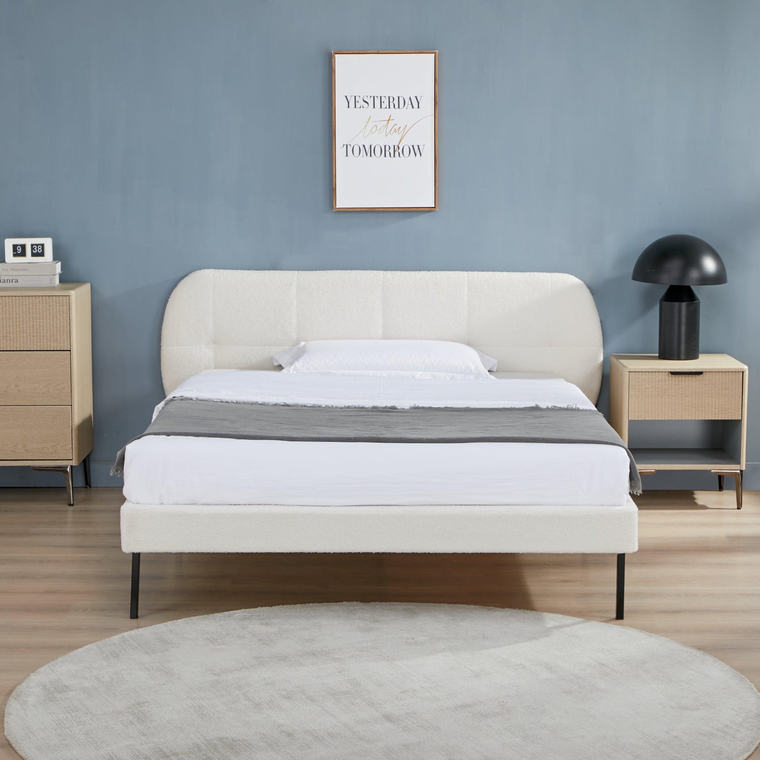 Modern bedroom with a bed, nightstands, and wall art.