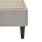Gray upholstered bed frame with wooden slats on a white background