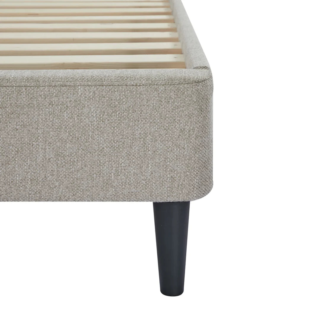 Gray upholstered bed frame with wooden slats on a white background